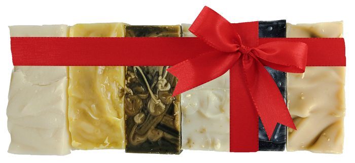 Five bars of Pierre's Scrub Shop soap lined up side by side and tied together with a red ribbon