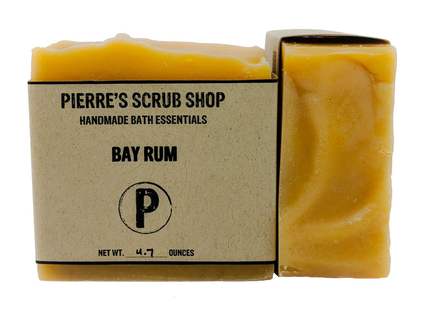 A Bay Rum bar in its kraft paper wrapper beside an unwrapped golden bar