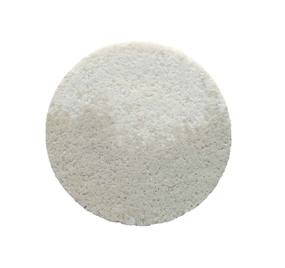 A round pale bath bomb photographed from above
