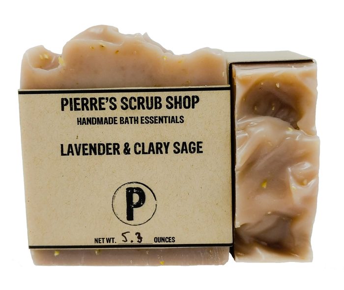 A Lavender & Clary Sage bar in its kraft paper wrapper beside an unwrapped pink and brown swirled bar
